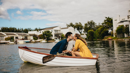 Wall Mural - Couple on a date kissing in a boat