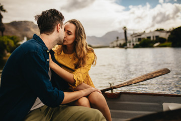 Wall Mural - Couple kissing on a boat