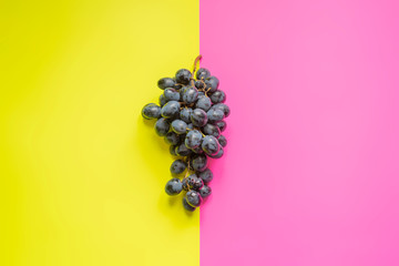 Wall Mural - top view of flat lay of bunch of grapes on double color sirface background f