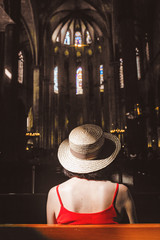 Wall Mural - Woman seating in dark interior of a Church, Religion Concept