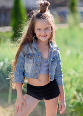 portrait of little girl outdoors in summer