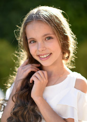 portrait of little girl outdoors in summer