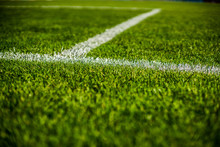 Green Bright Colorful Grass Pitch Of Football Stafium, Close Up With Beautiful Bokeh And Stripes