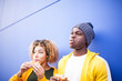 © David Fuentes - afro couple enjoying a hamburger