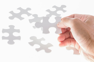 Man hand holding jigsaw puzzle