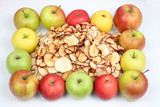 Fototapeta Kuchnia - Dried Apple slices surrounded by fresh apples on white background