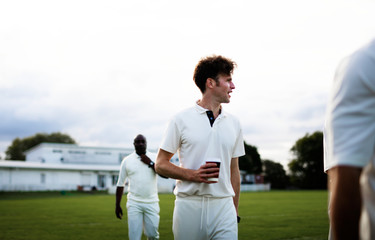 Wall Mural - Cricket player holding a coffee paper cup