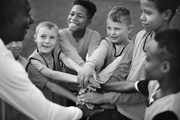 Sticker - Junior football team stacking hands before a match