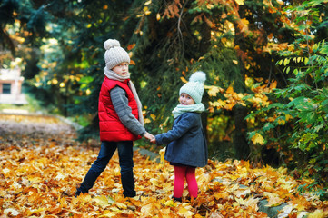 Children on an autumn walk, brother and sister in the Park on an autumn day