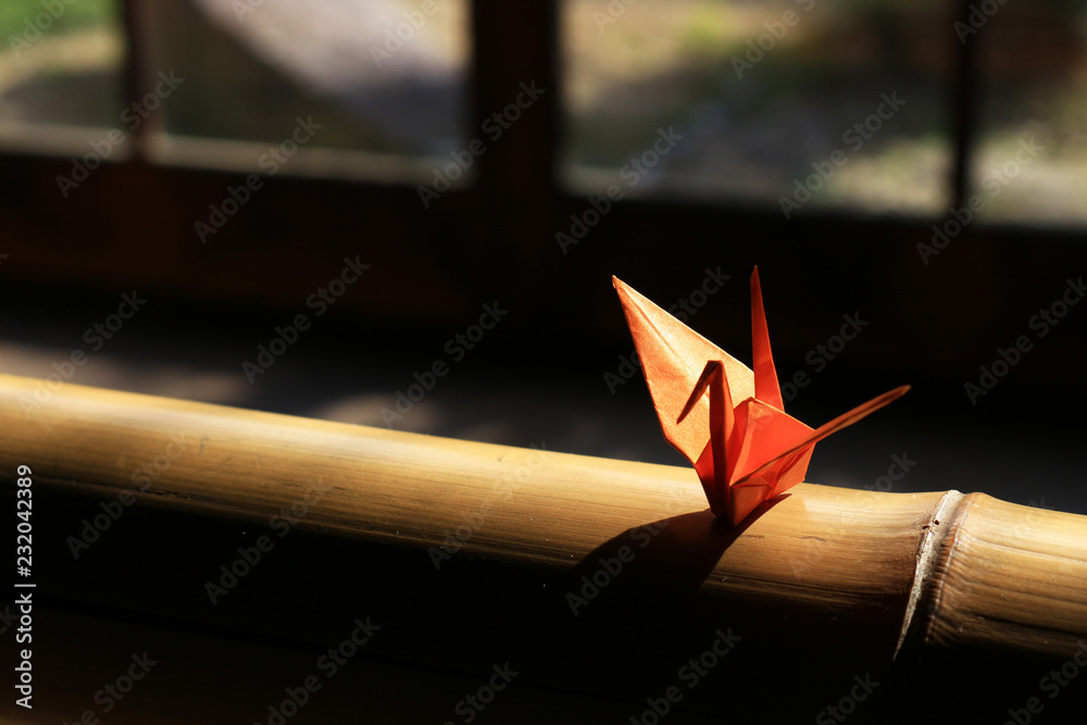 Origami crane which is placed on the window side of Japanese style houses - obrazy, fototapety, plakaty 