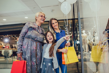 Wall Mural - Mother, adult daughter and granddaughter in shopping mall together