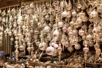 Wall Mural - White and silver christmas tree ornaments and balls, advent market stall close up, photo