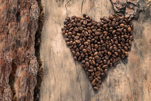 Coffee In Form Of Heart On Grunge Wooden Background. Top View.