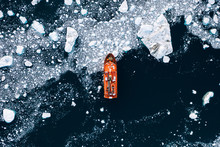 Minimalistic Aerial View Of An Orange Icebreaker In Sea Ice