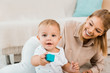 © LIGHTFIELD STUDIOS - adorable toddler looking at camera and playing with colorful cube and mother