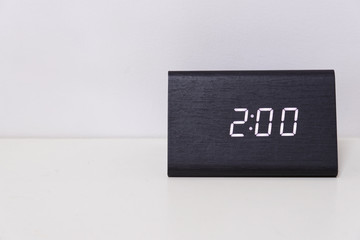 Black digital clock on a white background showing time 2:00