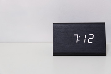 Black digital clock on a white background showing time 7:12