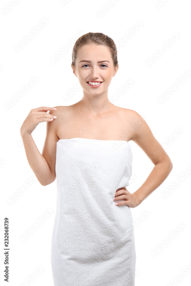 Beautiful young woman wrapped in towel on white background