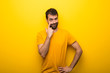 © luismolinero - Man on isolated vibrant yellow color looking to the front