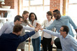 © fizkes - Excited multiracial colleagues give high five involved in teambuilding activity at meeting, happy diverse workers join hands celebrate success or win, show team spirit and unity. Cooperation concept