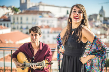 Beautiful fado singer performing with handsome portuguese guitarist player, Portugal