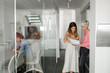 © LUMINA IMAGES - Two beautiful businesswomen standing on hallway and looking at paper document.