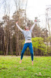 © YKD - Girl with sunglasses jumping on the grass lawn
