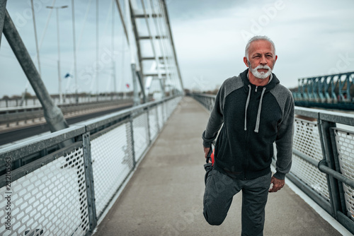 Fit looking older man warming up before exercise