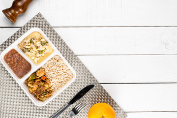 Meat minced with vegetables and polenta with asparagus and scrambled eggs.Brazilian lunch box. Ahead meal preparation or dieting concept. top view.