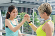 © TeTe Song - Shot of sport womens friends giving high-five at street city. Professional sport shaking hands after the game.