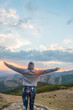 © ADDICTIVE STOCK - Happy woman in mountains with sunset sky