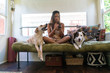 © Schultz-West Images - Woman sitting on couch with Dogs