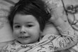 © alexkich - Black and white photo portrait of a young child lying on a pillow