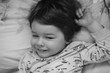 © alexkich - Black and white photo portrait of a young child lying on a pillow