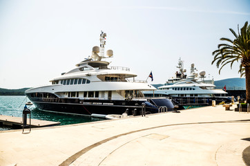 Two dazzling white luxury yachts at the pier of Bay of Kotor. Tivat, Montenegro