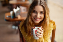 Young Charming Woman Having Coffee In A Coffee Shop