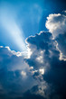Heavenly light shining through billowing clouds in a stormy sky