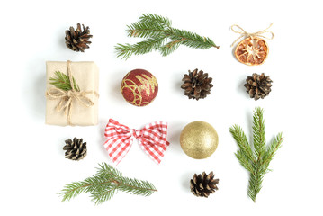 christmas composition of christmas balls, gift box, cones and fir branches isolated on white backgro