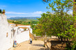 © pkazmierczak - RONDA, SPAIN - MAY 10, 2018: Couple of people walking down the street in Ronda village, Andalusia, Spain. This place is famous tourist destination.