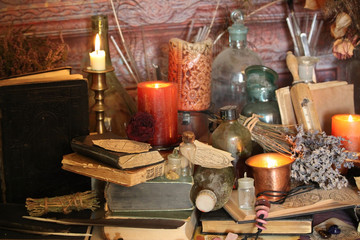 Wall Mural - Antique Magic Book. Witchcraft Peacock feathers and candle background. Black candle Magic Ritual.