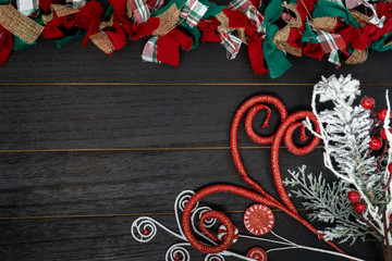 Wall Mural - Christmas holiday background with glittery floral elements and a festive fabric garland. Wood background