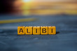 Alibi on wooden blocks. Cross processed image with bokeh background