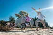 Warrior pose. Healthy girlfriend and boyfriend standing in warrior pose doing yoga outside their mobile home