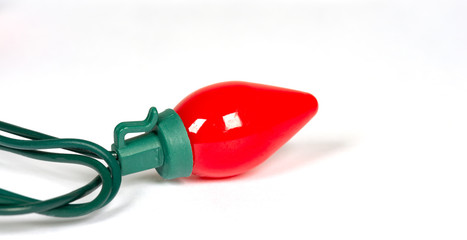 Wall Mural - red retro led bulb light with reflection isolated on white with a shallow depth of field