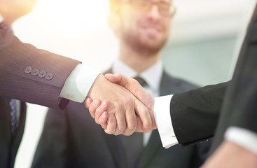 closeup handshake proven business partners