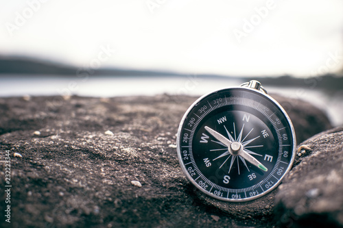 Fotografía compass on rock in the nature, color vintage style