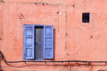 Blue wooden window on the old pink wall.