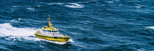 Coast Guard Boat Patrol Riding On Rough Sea Waves In Alaska. Panoramic Banner Background.