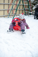 Wall Mural - Child playing in the snow outdoor