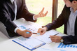 © Prathankarnpap - Businessman consulting with finance document paper.